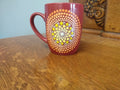 Red mug with yellow and orange dot art mandala
